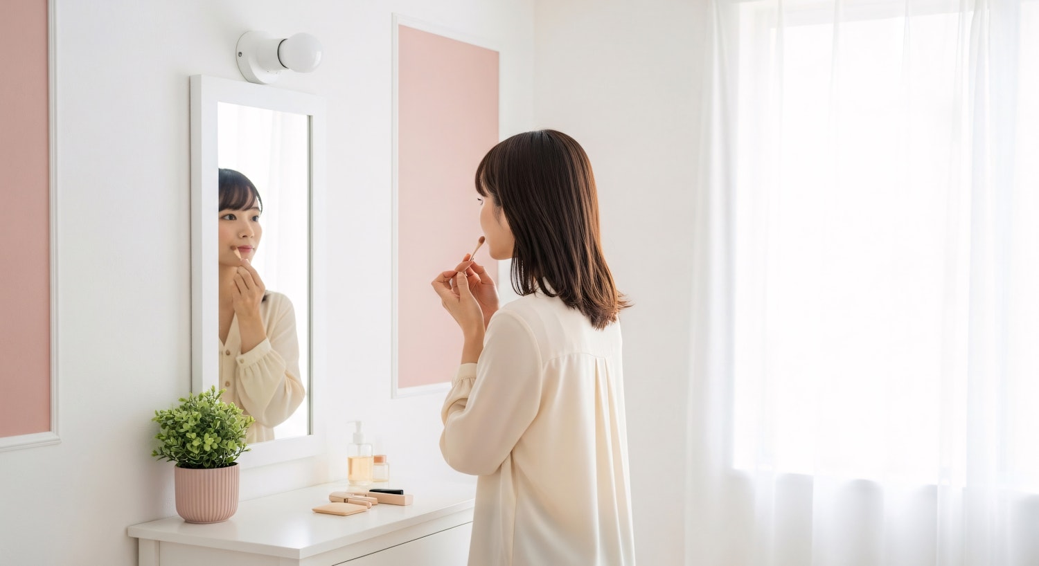 A creator applying makeup at a mirror in natural light.